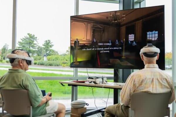 Two individuals participate in "The Great Experiment" virtual reality experience.